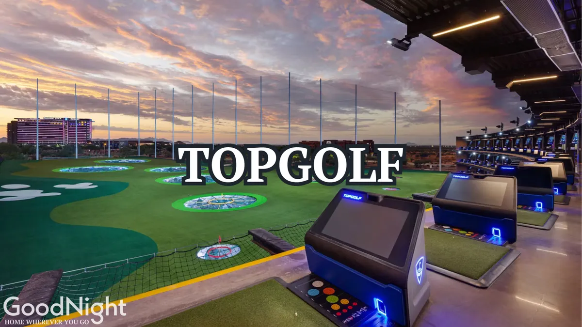 A lively golf driving range at sunset features digital screens and open-air bays, exuding a social and energetic atmosphere perfect for group outings. The sky glows with evening colors, hinting at memorable moments spent golfing and celebrating with friends.