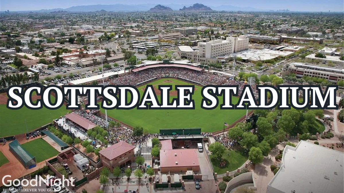 A vibrant exterior view of Scottsdale Stadium, bustling with spectators enjoying a baseball game. The field is framed by the surrounding cityscape, capturing the energy of live sports and proximity to major local venues.